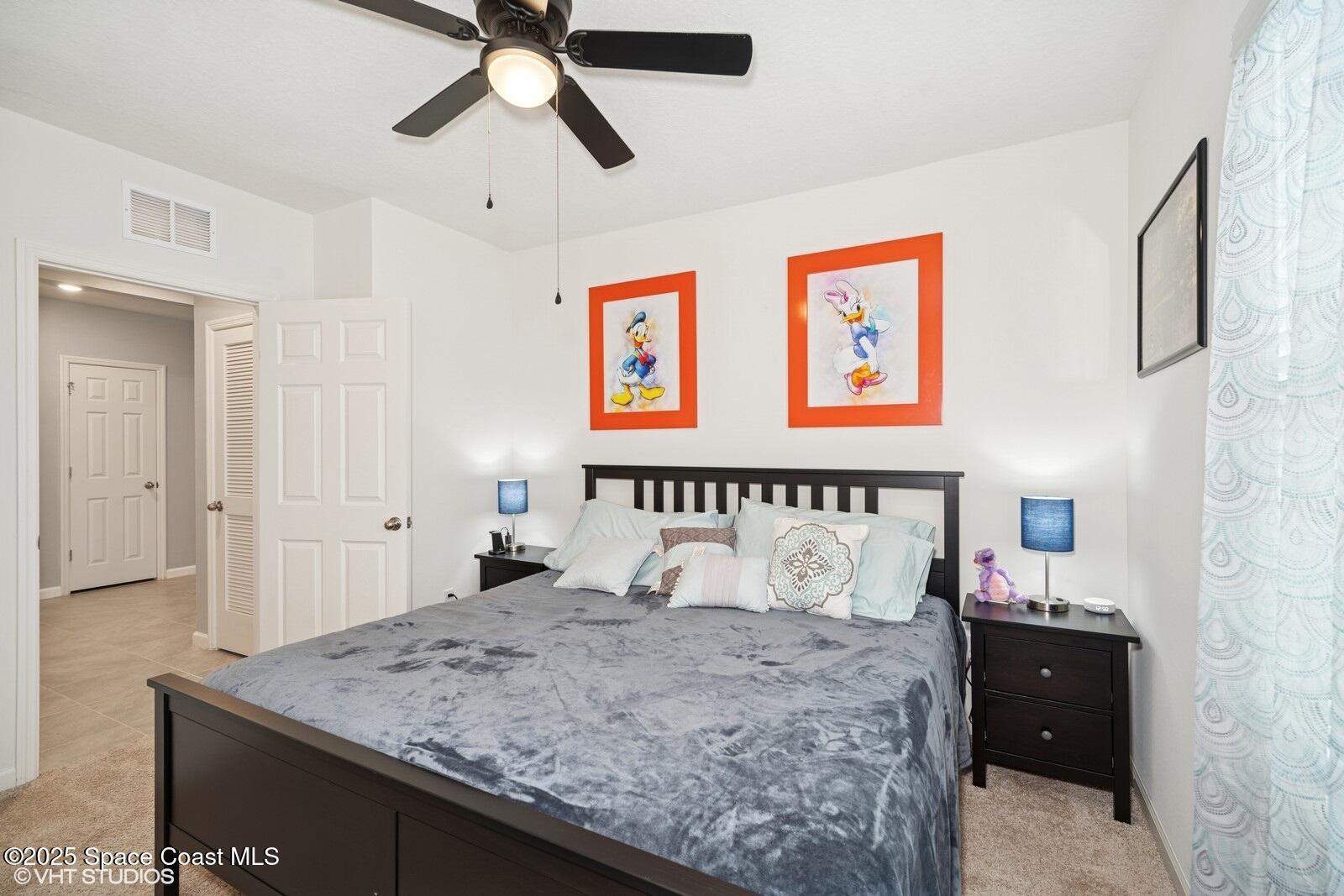 5221 Talbot Boulevard Cocoa, FL 32926 - Photo 20 of 32 a bedroom with a bed and a chandelier