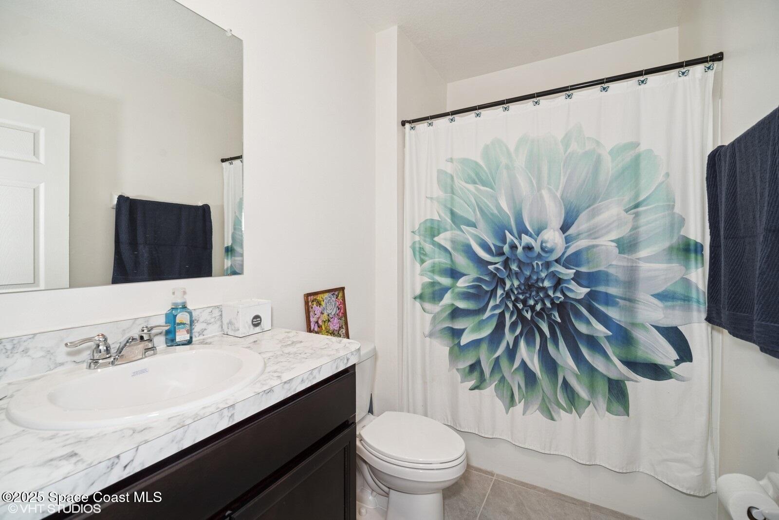 5221 Talbot Boulevard Cocoa, FL 32926 - Photo 26 of 32 a bathroom with a granite countertop sink a toilet and tub