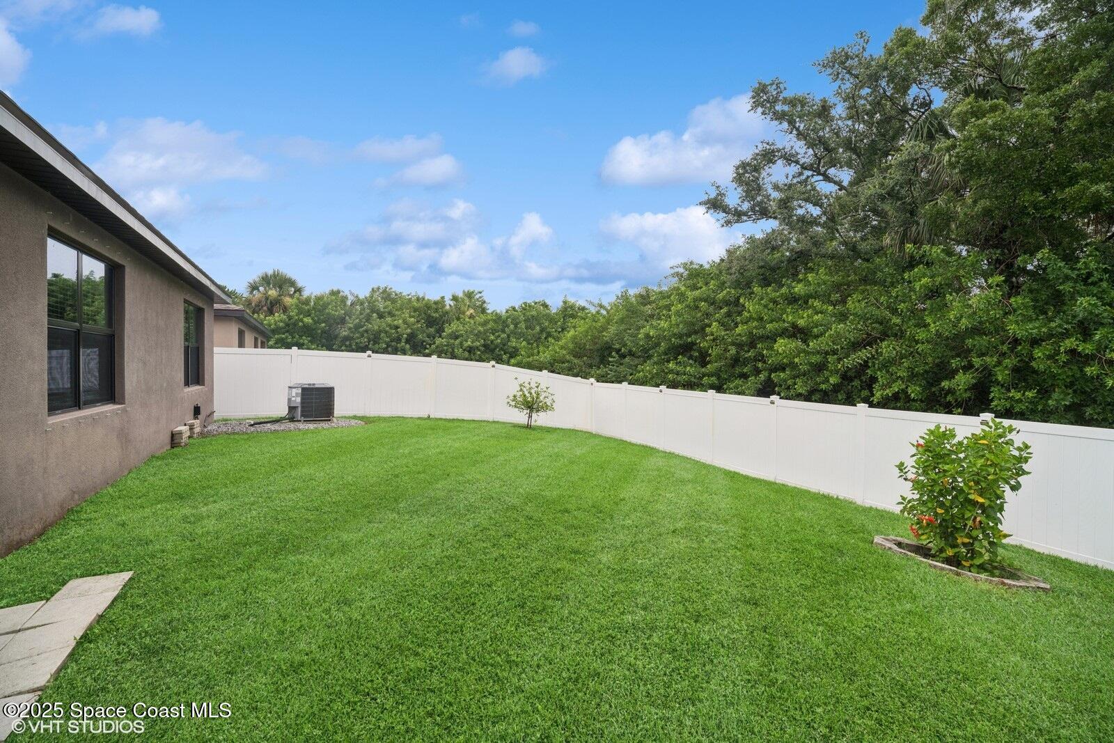 5221 Talbot Boulevard Cocoa, FL 32926 - Photo 29 of 32 a view of a backyard with grass and a large tree