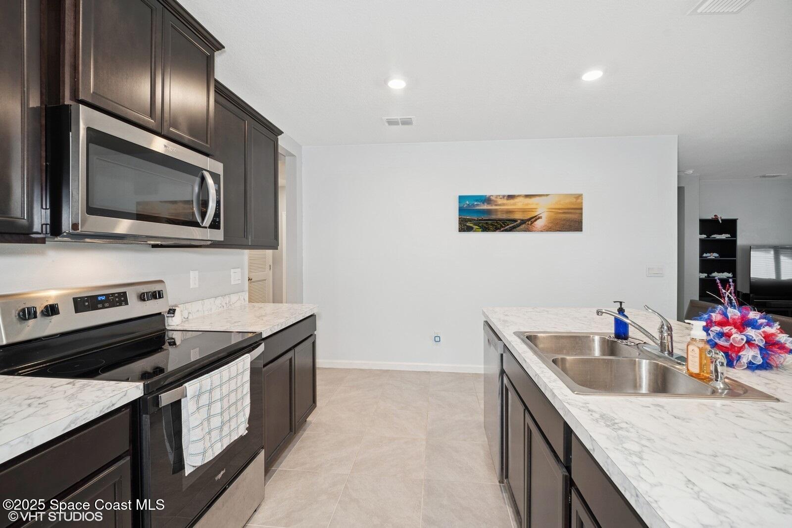 5221 Talbot Boulevard Cocoa, FL 32926 - Photo 10 of 32 a kitchen that has a sink and a stove