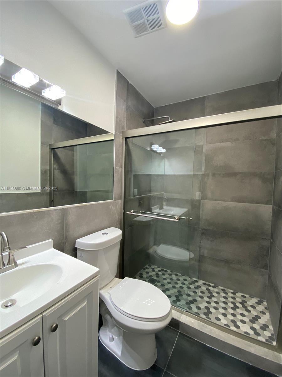 46 Northwest 44th Street, Unit 46 Miami, FL 33127 - Photo 13 of 16 a bathroom with a sink toilet and shower