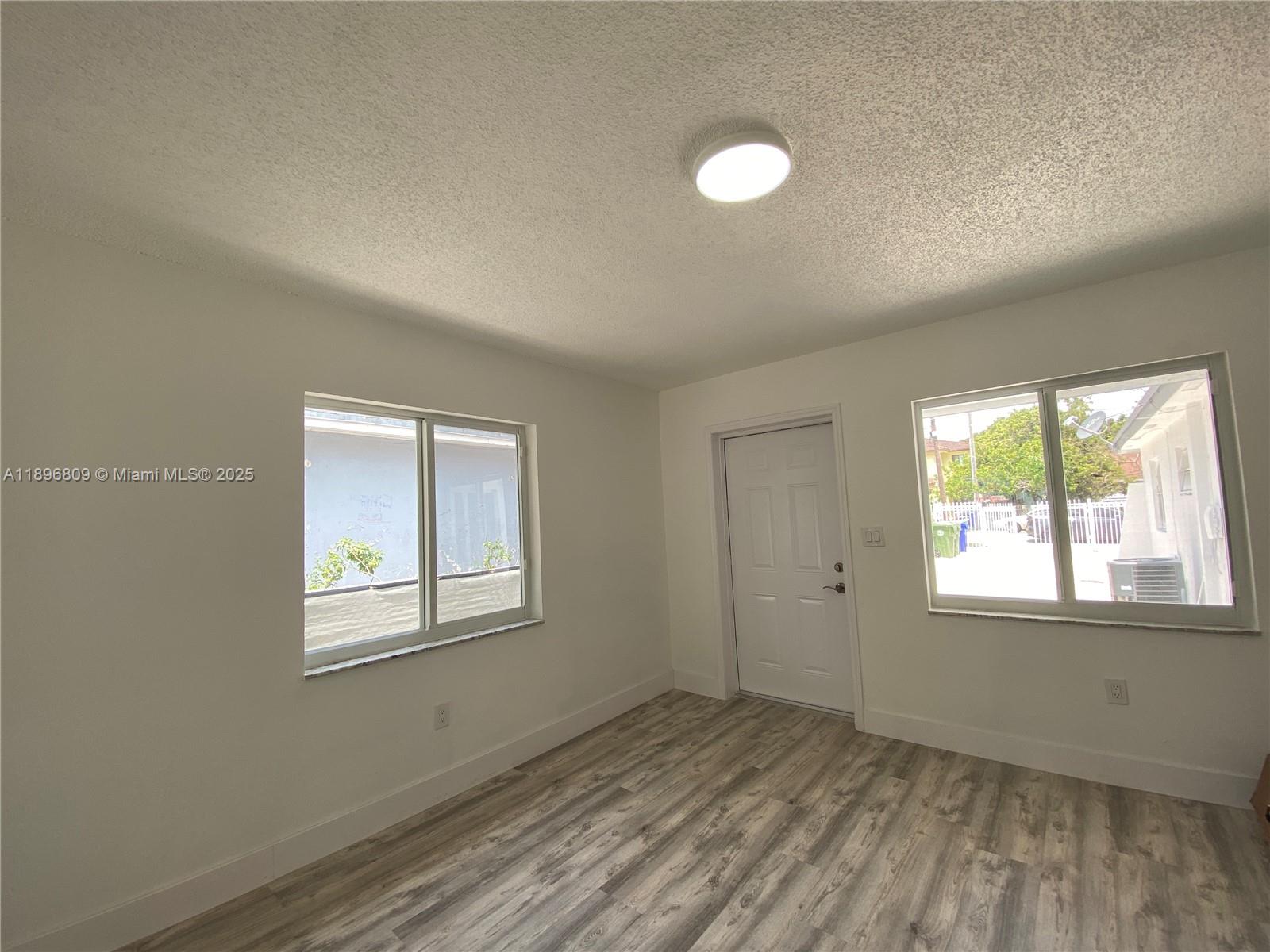 46 Northwest 44th Street, Unit 46 Miami, FL 33127 - Photo 3 of 16 an empty room with windows