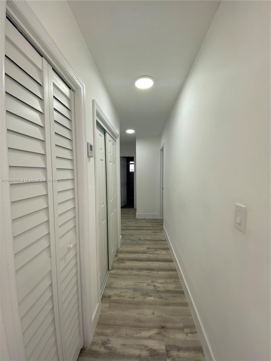 46 Northwest 44th Street, Unit 46 Miami, FL 33127 - Photo 4 of 16 a view of a hallway with wooden floor