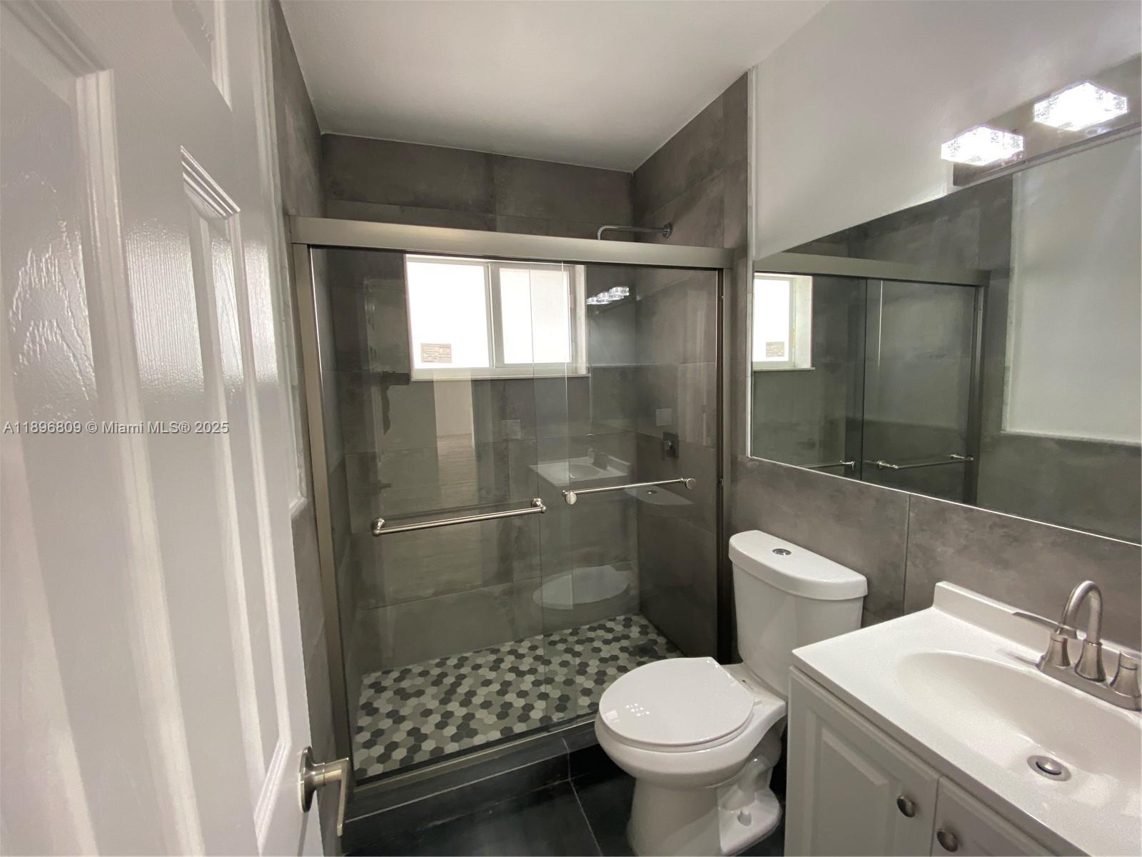 46 Northwest 44th Street, Unit 46 Miami, FL 33127 - Photo 5 of 16 a bathroom with a toilet and a shower