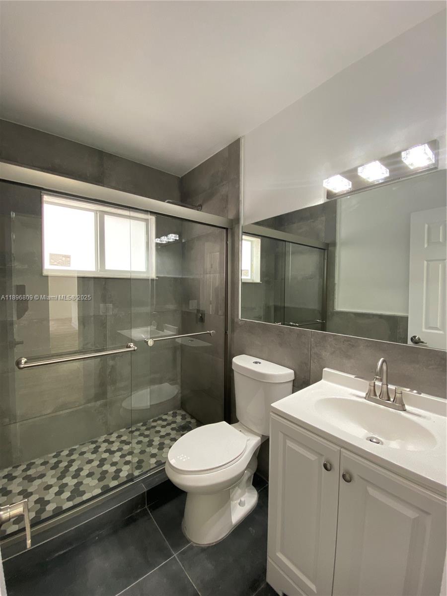 46 Northwest 44th Street, Unit 46 Miami, FL 33127 - Photo 10 of 16 a bathroom with a sink a toilet and shower