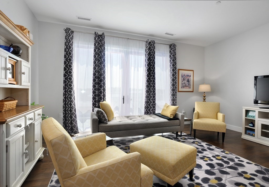 10 Shipyard Drive, Unit 401 Hingham, MA 02043 - Photo 11 of 24 a living room with furniture and wooden floor