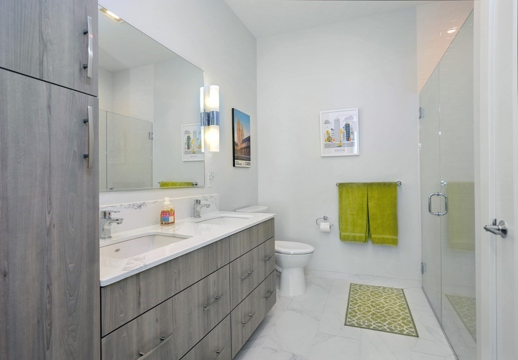 10 Shipyard Drive, Unit 401 Hingham, MA 02043 - Photo 15 of 24 a bathroom with a sink a toilet and shower