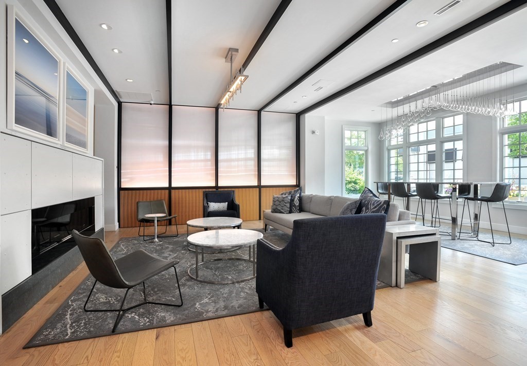 10 Shipyard Drive, Unit 401 Hingham, MA 02043 - Photo 2 of 24 a living room with fireplace furniture and a wooden floor