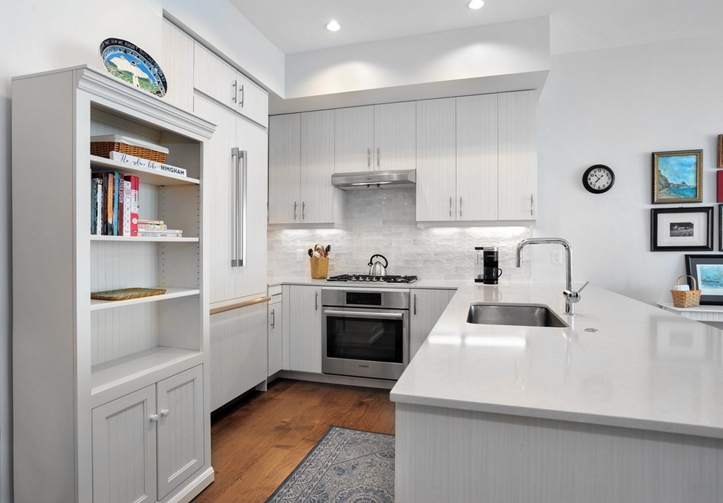 10 Shipyard Drive, Unit 401 Hingham, MA 02043 - Photo 4 of 24 a kitchen with a sink cabinets and appliances