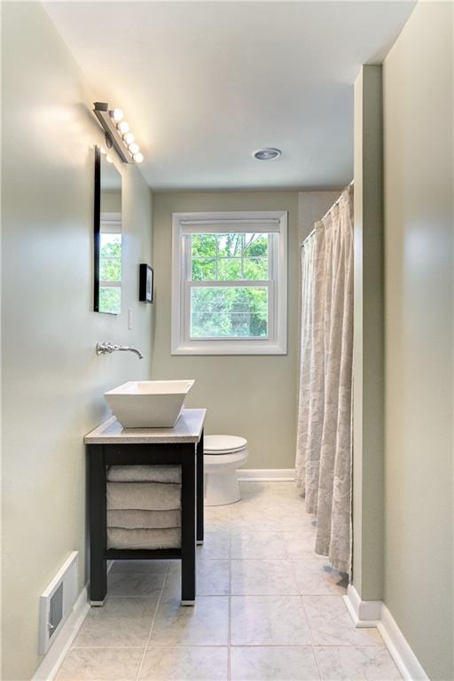 348 Scaife Road Sewickley, PA 15143 - Photo 18 of 25 a bathroom with a sink a toilet and a mirror