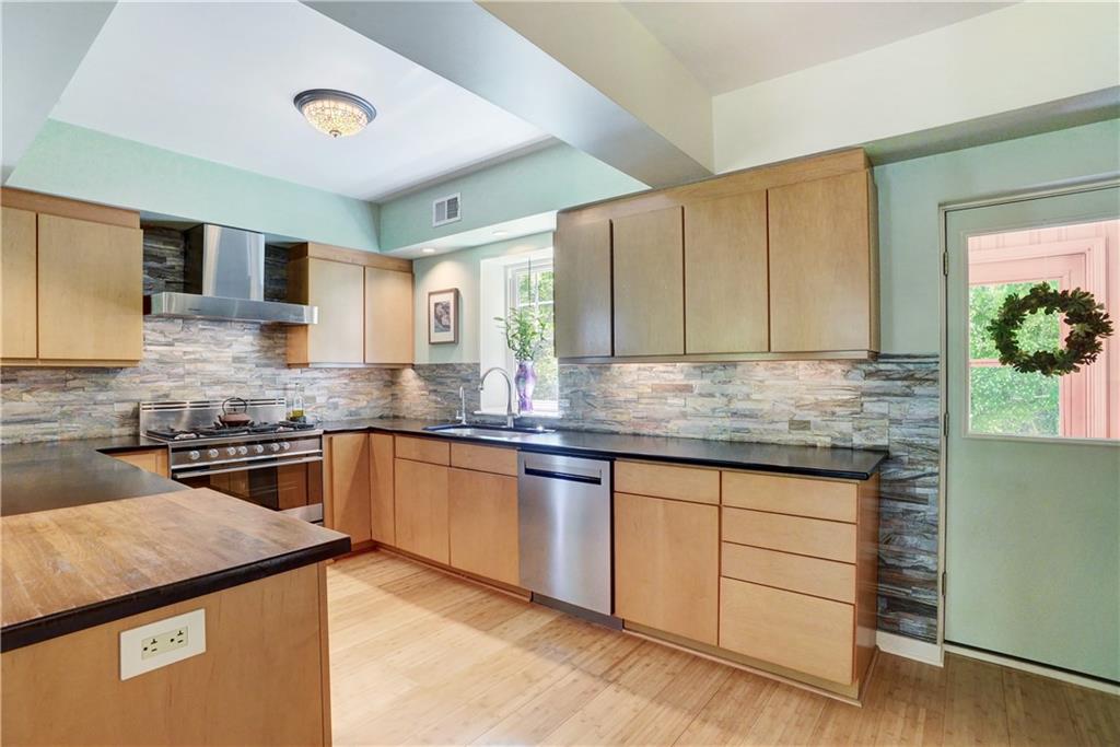 348 Scaife Road Sewickley, PA 15143 - Photo 9 of 25 a kitchen with stainless steel appliances granite countertop a sink and stove top oven