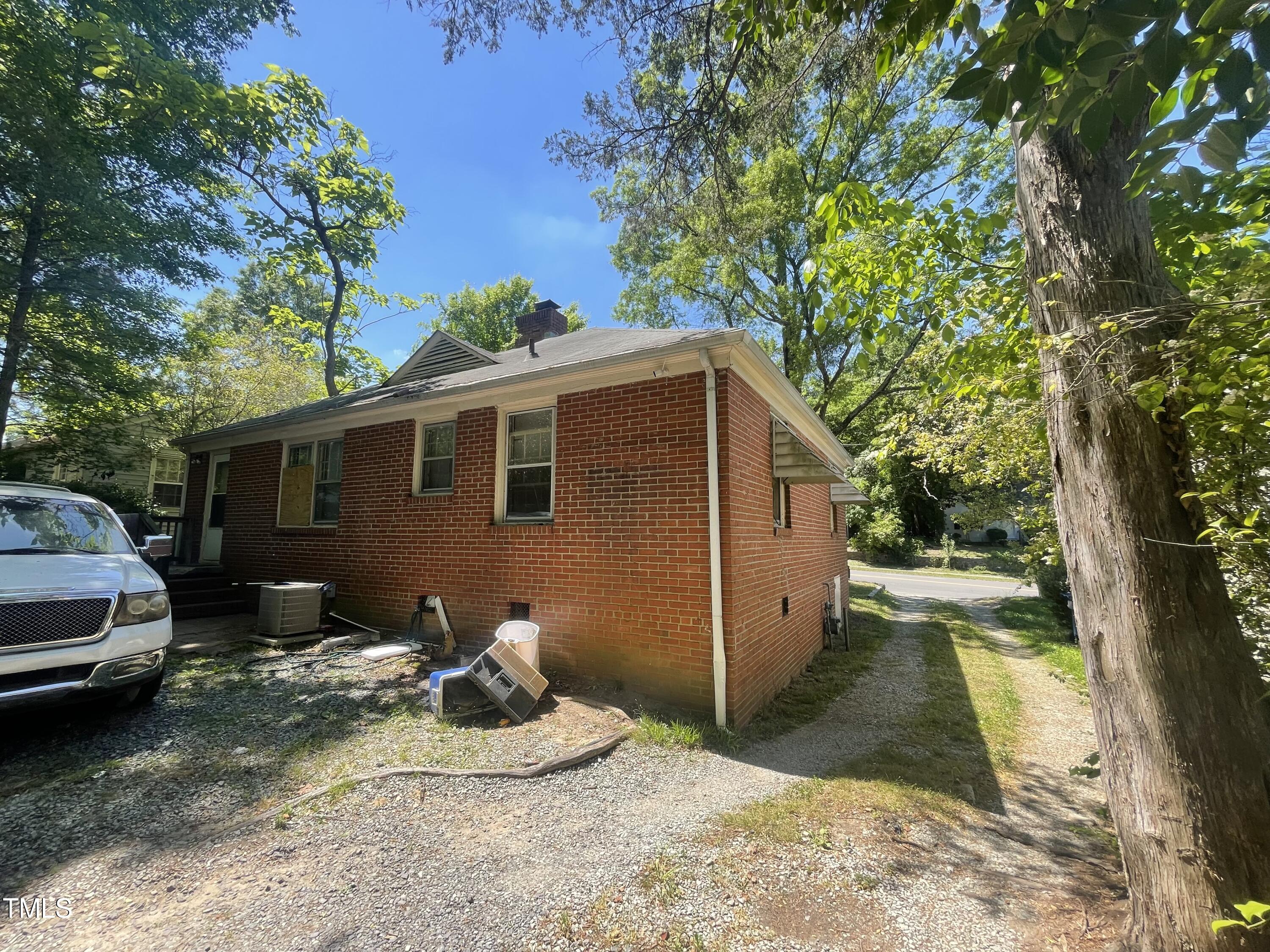 2204 Guess Road Durham, NC 27705 - Photo 14 of 15 a backyard of a house with table and chairs under an umbrella