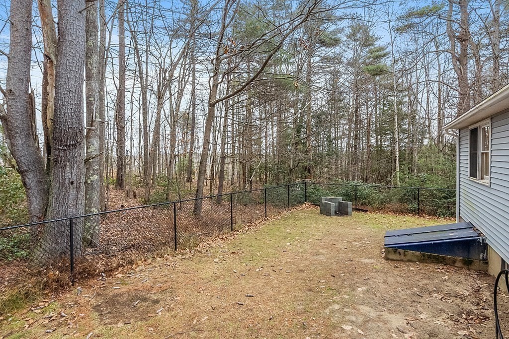 628 Teel Road Winchendon, MA 01475 - Photo 32 of 38 a backyard of a house with lots of green space and fountain