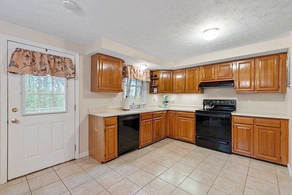 628 Teel Road Winchendon, MA 01475 - Photo 5 of 38 a kitchen with stainless steel appliances granite countertop a stove sink and cabinets