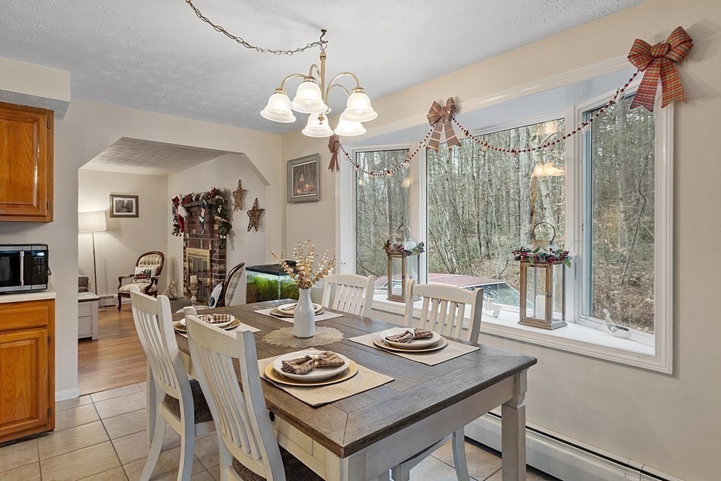 628 Teel Road Winchendon, MA 01475 - Photo 10 of 38 a view of a dining room with furniture a chandelier and wooden floor