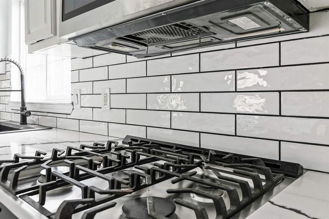 a kitchen with a sink cabinets and a stove top oven