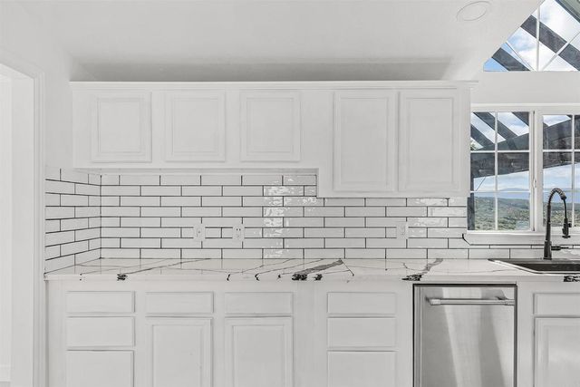 a view of a bedroom with wooden floor and window