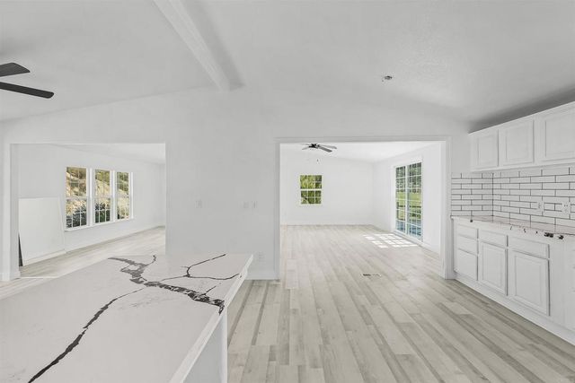 a view of a room with wooden floor and a window