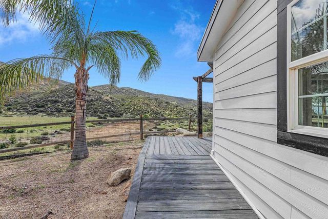 a view of a balcony with wooden floor