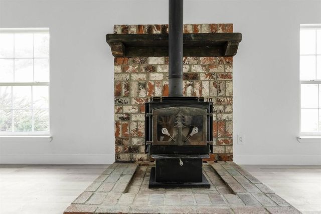 a kitchen with granite countertop a sink stove and cabinets