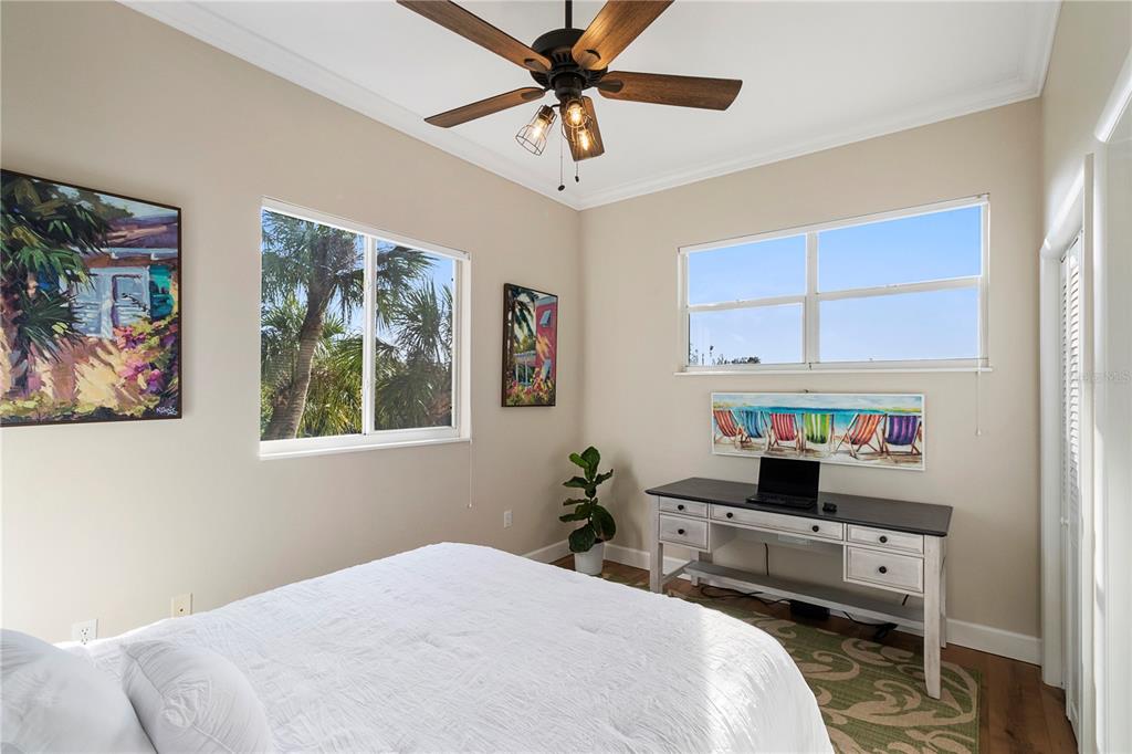 7325 Holly Road Terra Ceia, FL 34250 - Photo 25 of 87 a bedroom that has a bed and a chandelier