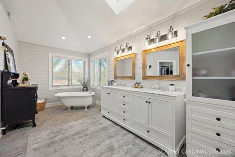 a spacious bathroom with a double vanity sink and mirror