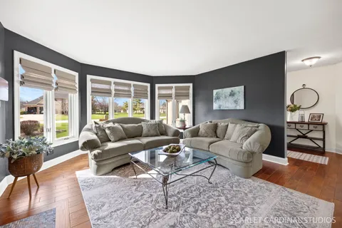 a living room with furniture a rug and a large window