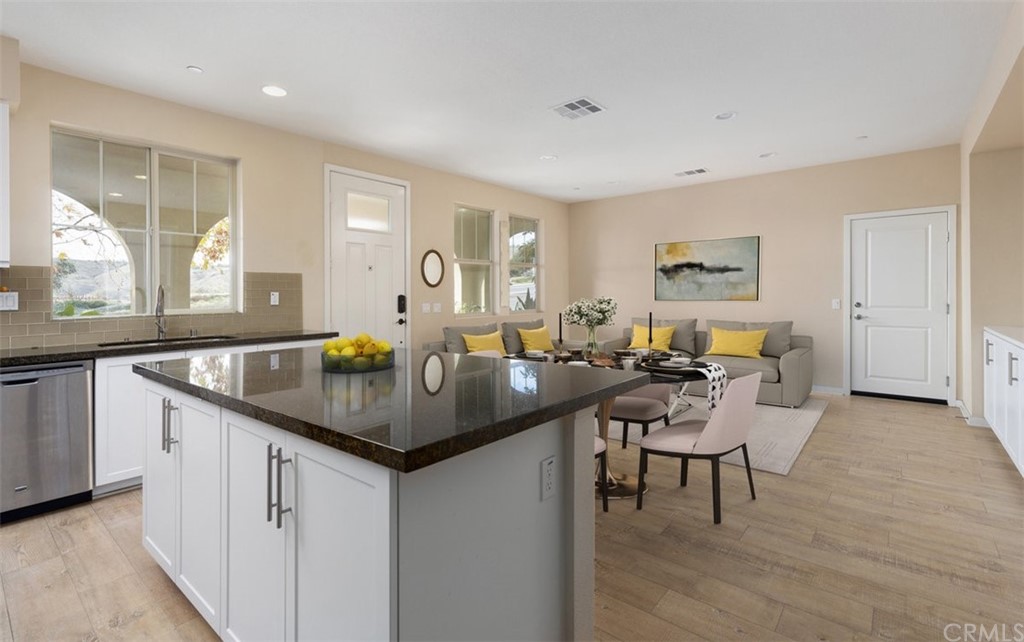 2 Adelfa Street Rancho Mission Viejo, CA 92694 - Photo 11 of 56 a kitchen with a table chairs and a refrigerator