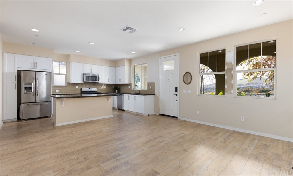 2 Adelfa Street Rancho Mission Viejo, CA 92694 - Photo 3 of 56 a kitchen with stainless steel appliances granite countertop a refrigerator and a stove top oven
