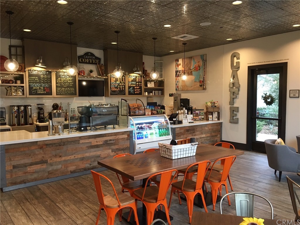 2 Adelfa Street Rancho Mission Viejo, CA 92694 - Photo 54 of 56 a kitchen with stainless steel appliances granite countertop a stove a sink dishwasher and cabinets with wooden floor
