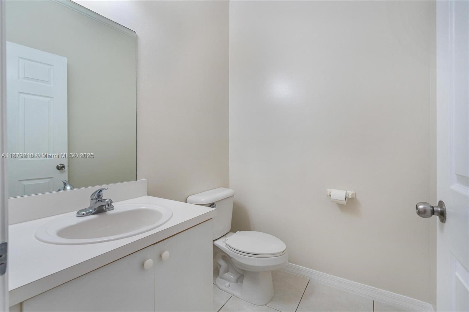 9135 Southwest 203rd Terrace Cutler Bay, FL 33189 - Photo 25 of 27 a bathroom with a sink toilet and a mirror