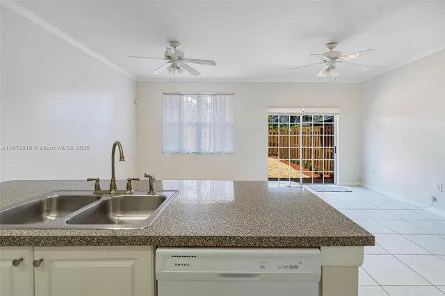 a kitchen with stainless steel appliances granite countertop a sink a granite counter tops and a window