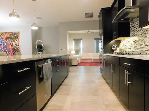 a large kitchen with kitchen island a sink a counter space and stainless steel appliances