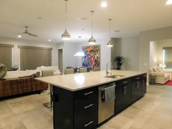 a kitchen with stainless steel appliances kitchen island granite countertop a stove and a microwave