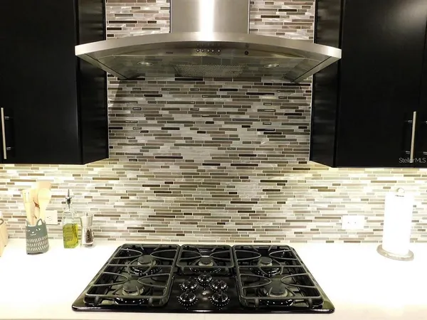 a kitchen with kitchen island a counter top space appliances and cabinets