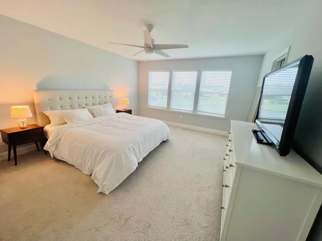 a bedroom with a bed and a chair in it