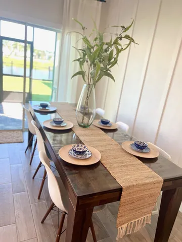 a dining room with furniture and a potted plant