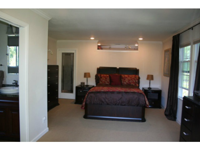 14754 Bronson Avenue San Jose, CA 95124 - Photo 11 of 18 a bedroom with a bed and a mirror