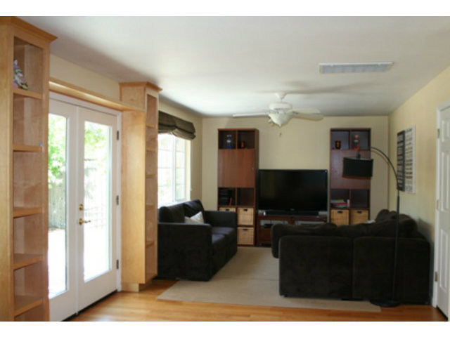 14754 Bronson Avenue San Jose, CA 95124 - Photo 6 of 18 a living room with furniture a flat screen tv and a fireplace
