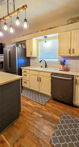 a kitchen with stainless steel appliances granite countertop a sink and cabinets