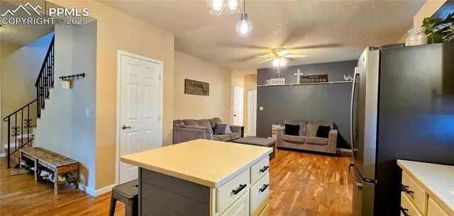 a view of a livingroom with furniture and a kitchen