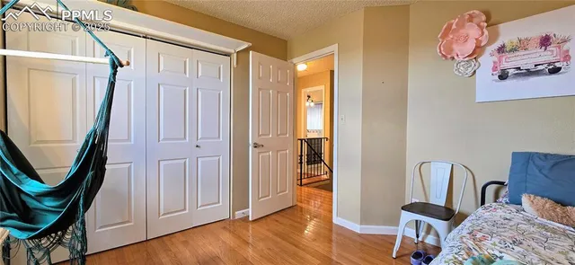 a view of a hallway with wooden floor and closet