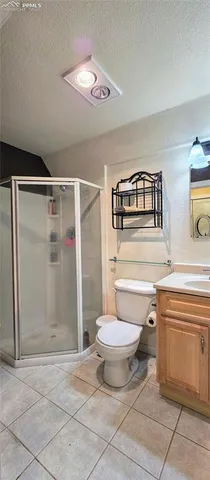 a bathroom with a toilet a sink and shower