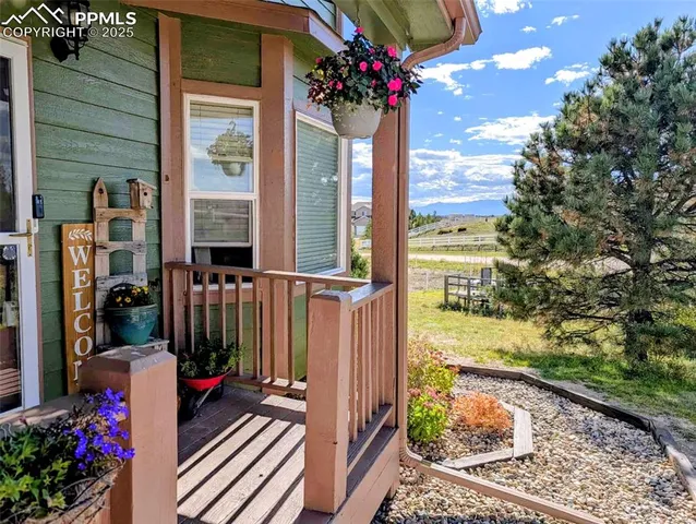 a view of a porch with a flower garden