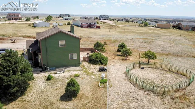 a view of a house with a yard and a mountain view