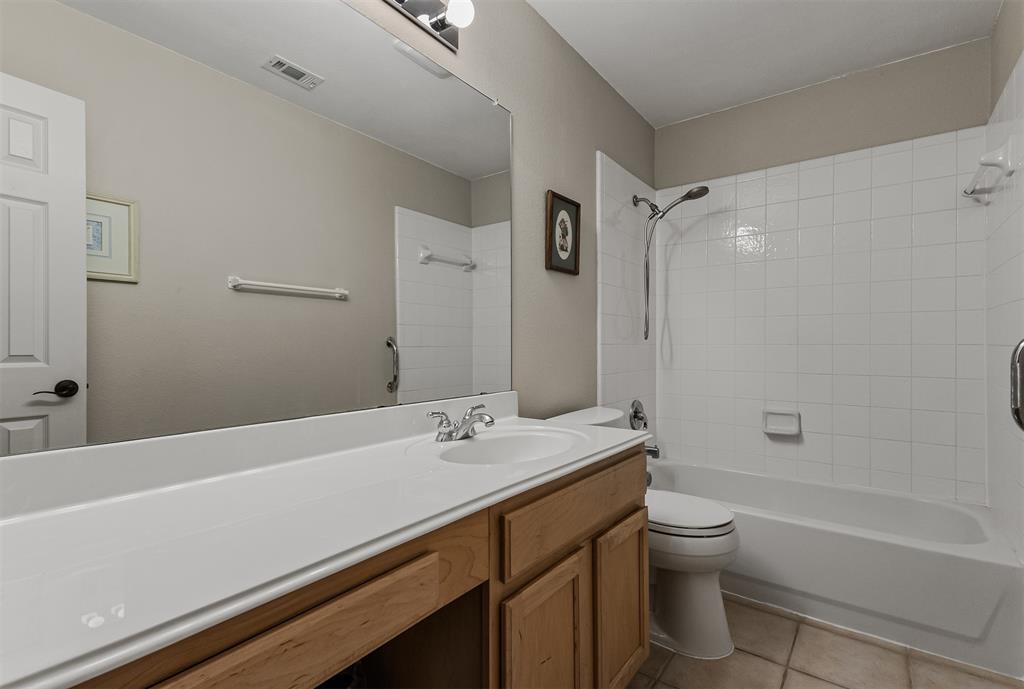 9301 Nottingham Court Rowlett, TX 75088 - Photo 20 of 39 Bathroom featuring a light wood-finish vanity with an integrated white sink and a large wall-mounted mirror