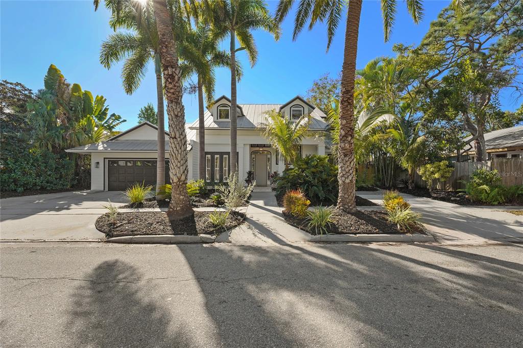 a view of a house with backyard and sitting area