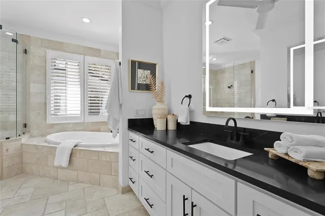 an empty room with wooden floor closet and windows