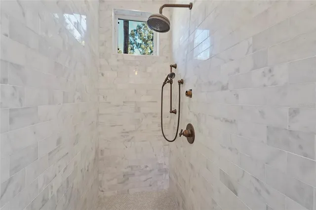 a living room with furniture and large windows