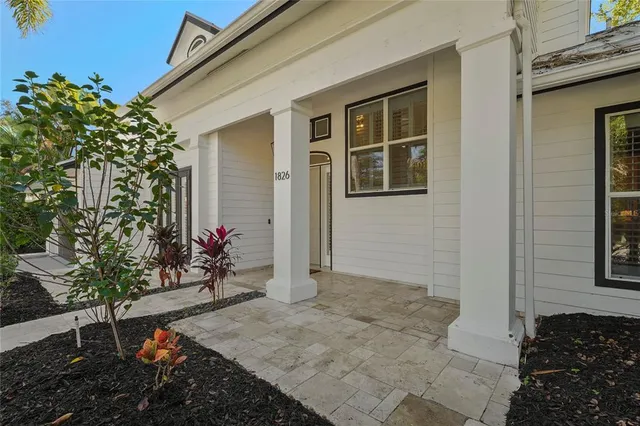a living room with furniture a large window and kitchen view
